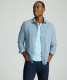 Model is wearing an UNTUCKit Alden gingham shirt in light blue.