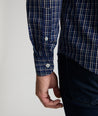 Model is wearing UNTUCKit Armstrong shirt in dark blue check.