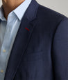 Model is wearing UNTUCKit Beasley sport coat in navy.