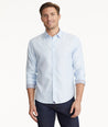 Model is wearing UNTUCKit Wrinkle-Free Burke Shirt in Textured Blue Chambray with Contrast Cuff.