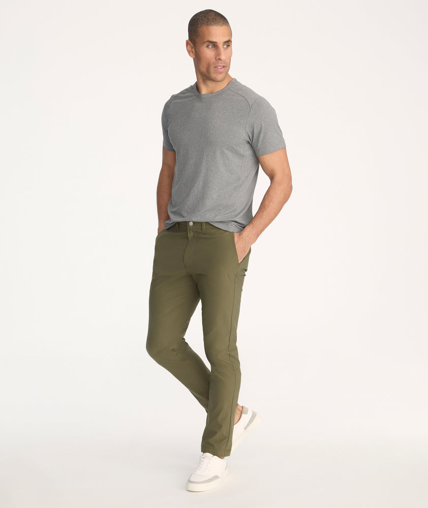 Model is wearing UNTUCKit Treveler Tech Pants in Ivy Green - full body