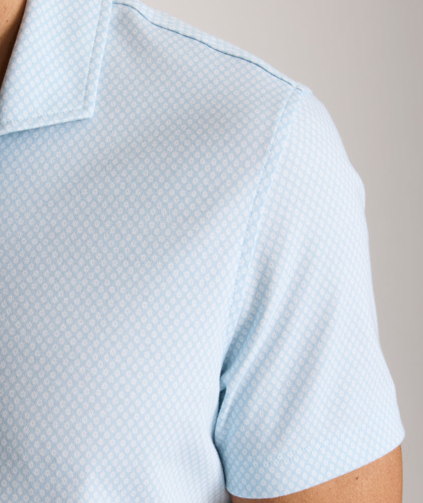 Model is wearing UNTUCKit Chen wrinkle free polo in blue.