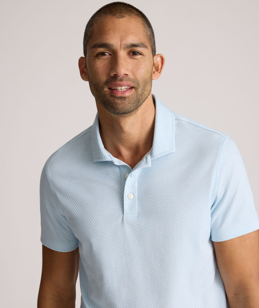 Model is wearing UNTUCKit Chen wrinkle free polo in blue.