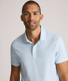 Model is wearing UNTUCKit Chen wrinkle free polo in blue.
