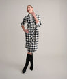 Model is wearing UNTUCKit Colby dress in buffalo check.