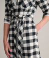 Model is wearing UNTUCKit Colby dress in buffalo check.