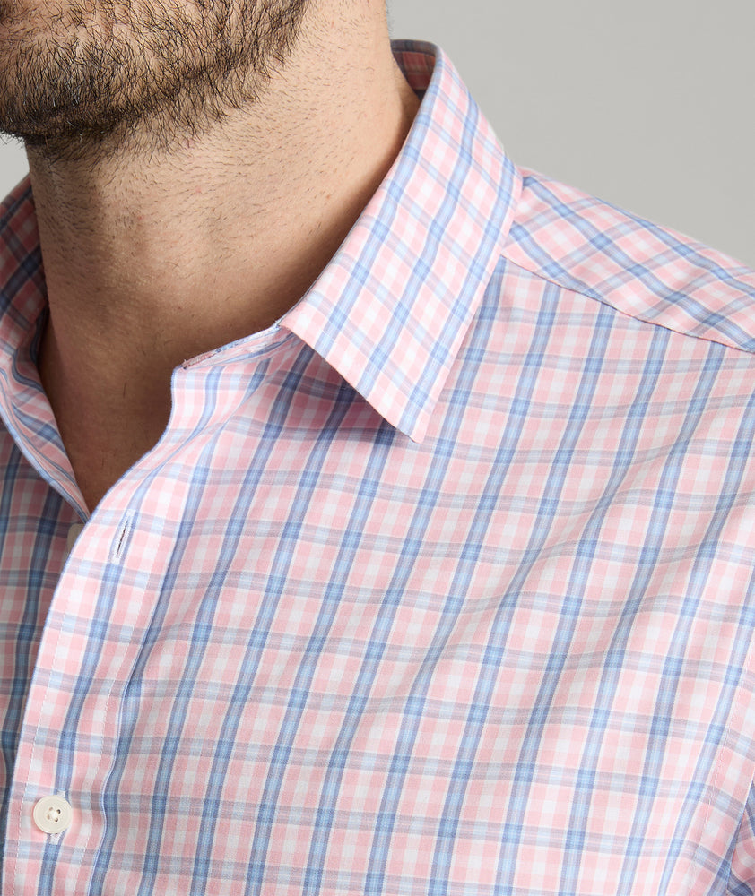 Model is wearing UNTUCKit Fairchild wrinkle free shirt in pink.