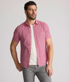Model is wearing UNTUCKit Forbes performance seersucker short sleeve shirt in pink.