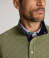Model is wearing UNTUCKit Garrison pullover in olivine.