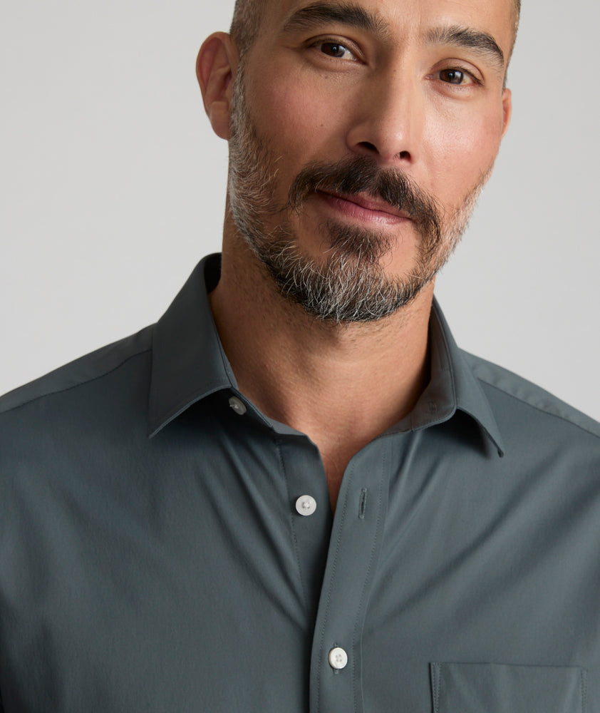 Model is wearing UNTUCKit girone performance shirt in urban chic.