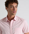 Model is wearing UNTUCKit Ingram short sleeve shirt in pink mini circle print.