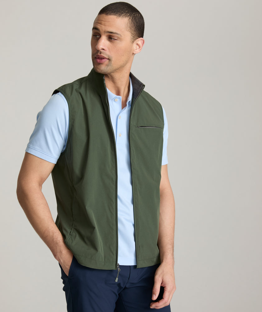 Model is wearing UNTUCKit Inman performance vest in green.