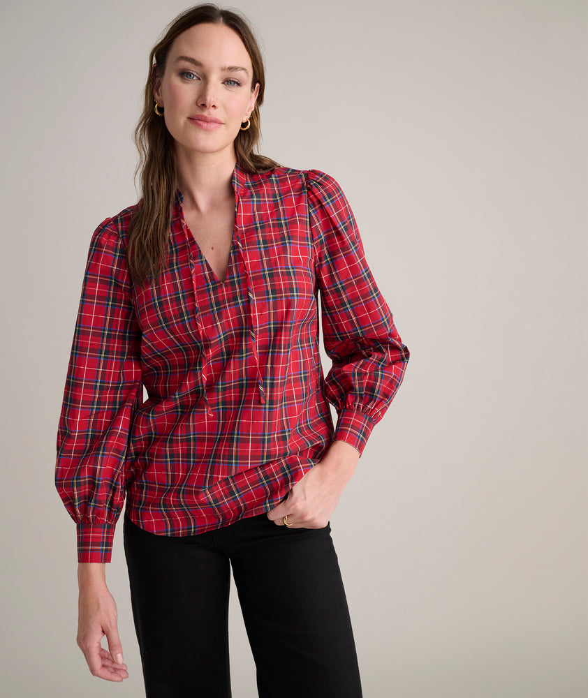 Model is wearing UNTUCKit Joy shirt in red plaid.