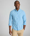 Model is wearing UNTUCKit Kenmare wrinkle-free shirt in teal check.