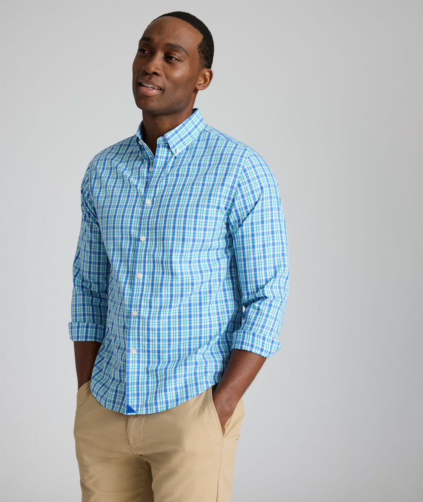 Model is wearing UNTUCKit Kenmare wrinkle-free shirt in teal check.