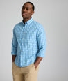 Model is wearing UNTUCKit Kenmare wrinkle-free shirt in teal check.