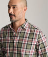 Model is wearing UNTUCKit Larson flannel in green grounded peach plaid.