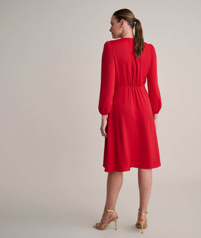Model is wearing UNTUCKit Malorie dress in red.