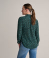 Model is wearing UNTUCKit Natalie top in green.