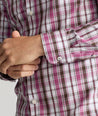 Model is wearing UNTUCKit parrish wrinkle free white grounded maroon plaid shirt.