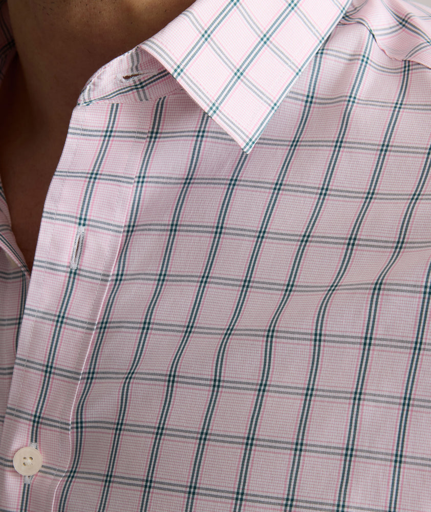 Model is wearing UNTUCKit Raynard cottentek shirt in pink windowpane.