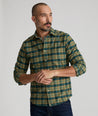 Model is wearing UNTUCKit Ryan performance shirt in green.