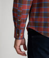 Model is wearing UNTUCKit Ryan performance shirt in Orange.