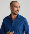 Model is wearing UNTUCKit Stanton shirt in blue Dimond print.