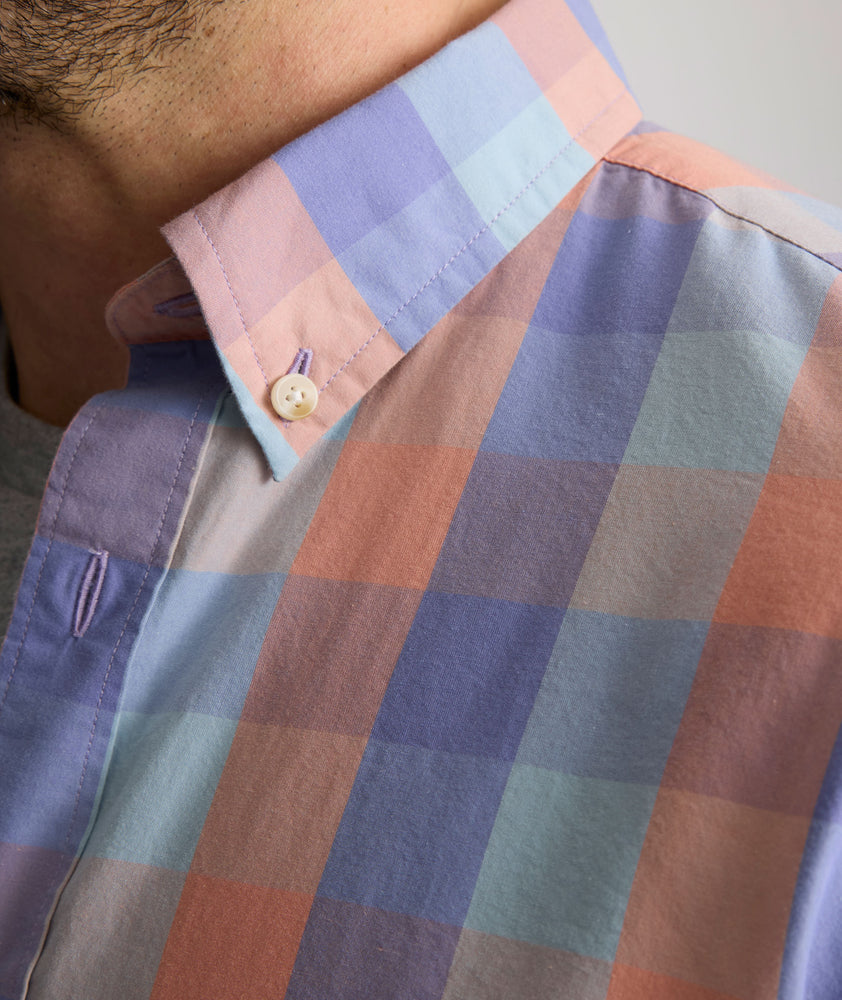Model is wearing UNTUCKit Stratford vintage wash in plaid orange.