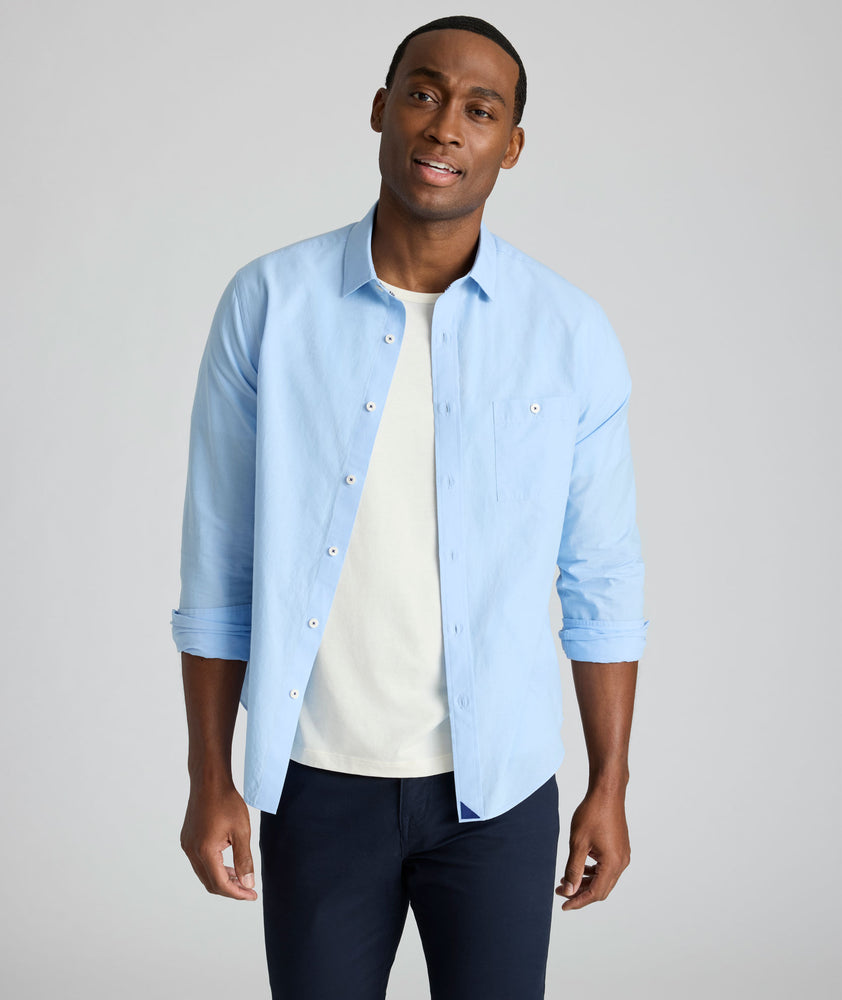 Model is wearing UNTUCKit Sutherland summer weight shirt in blue.