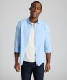 Model is wearing UNTUCKit Sutherland summer weight shirt in blue.