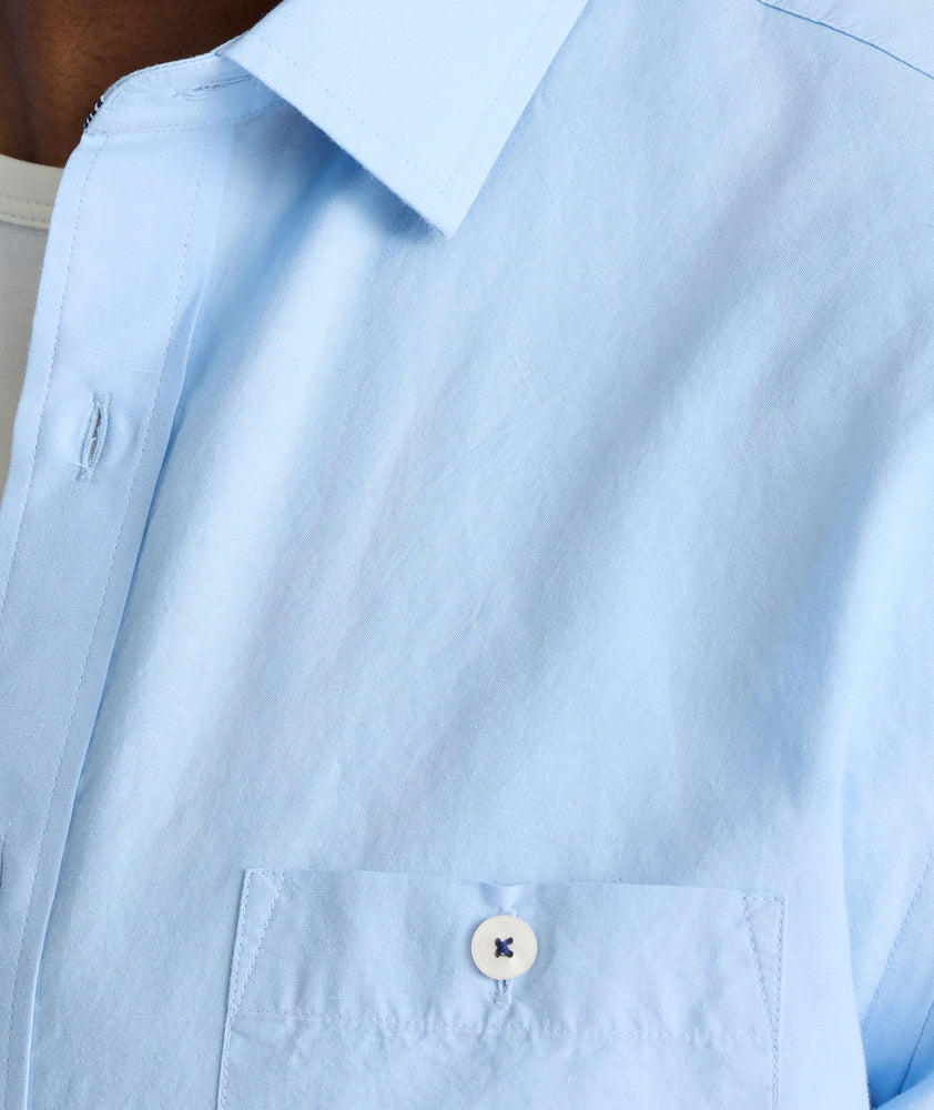 Model is wearing UNTUCKit Sutherland summer weight shirt in blue.