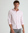Model is wearing Travers shirt in pink.