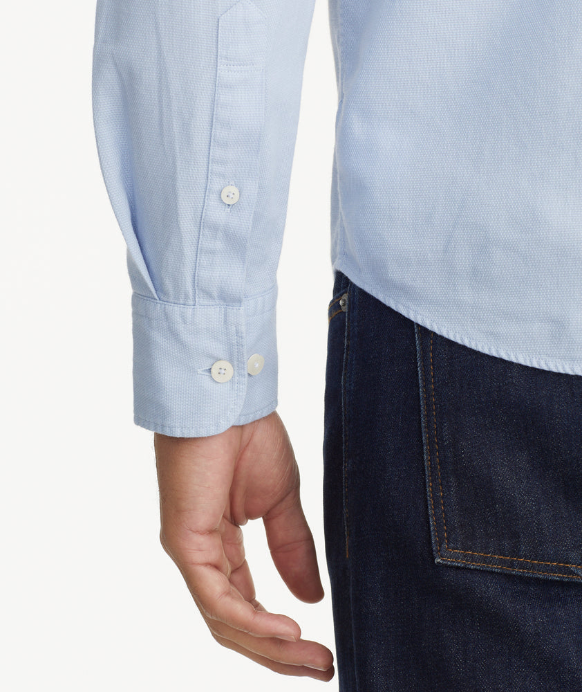 Model is wearing UNTUCKit Garment Dyed Cotton Pique Shirt in light blue.