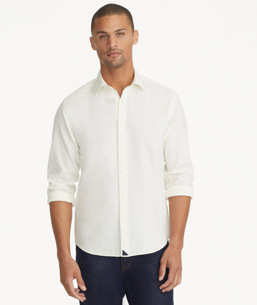 Model is wearing UNTUCKit Garment Dyed Cotton Pique Shirt in off-white.