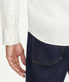 Model is wearing UNTUCKit Garment Dyed Cotton Pique Shirt in off-white.