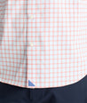 Model is wearing UNTUCKit Wells performance shirt in light blue and orange check.