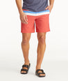 Model wearing UNTUCKit Mid Red 7-Inch Recycled Swim Trunks