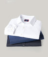 Stack of UNTUCKit gironde shirts in various colors. 