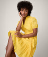 Model is wearing UNTUCKit solid Yellow Augusta Dress.