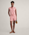 Model is wearing UNTUCKit Ada short in red. 