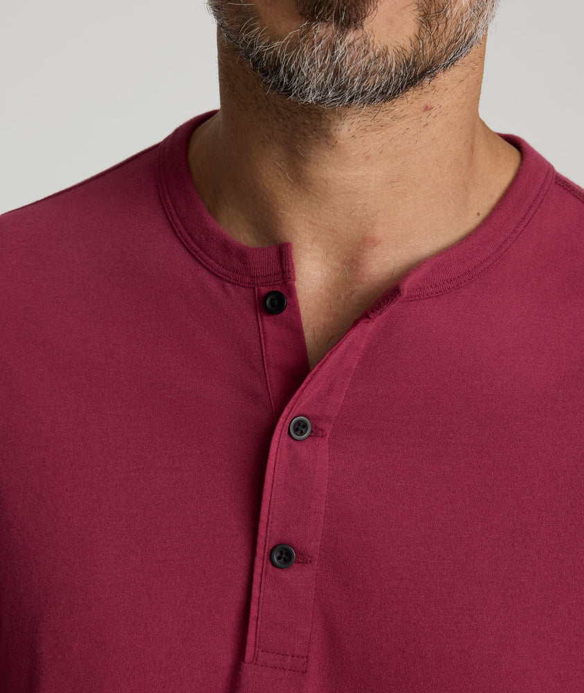 Model is wearing UNTUCKit Albarino Henley in Rhododrendron.