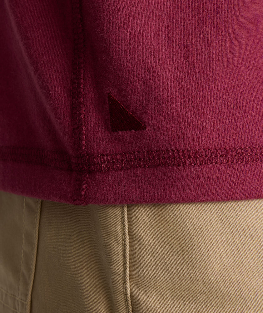 Model is wearing UNTUCKit Albarino Henley in Rhododrendron.