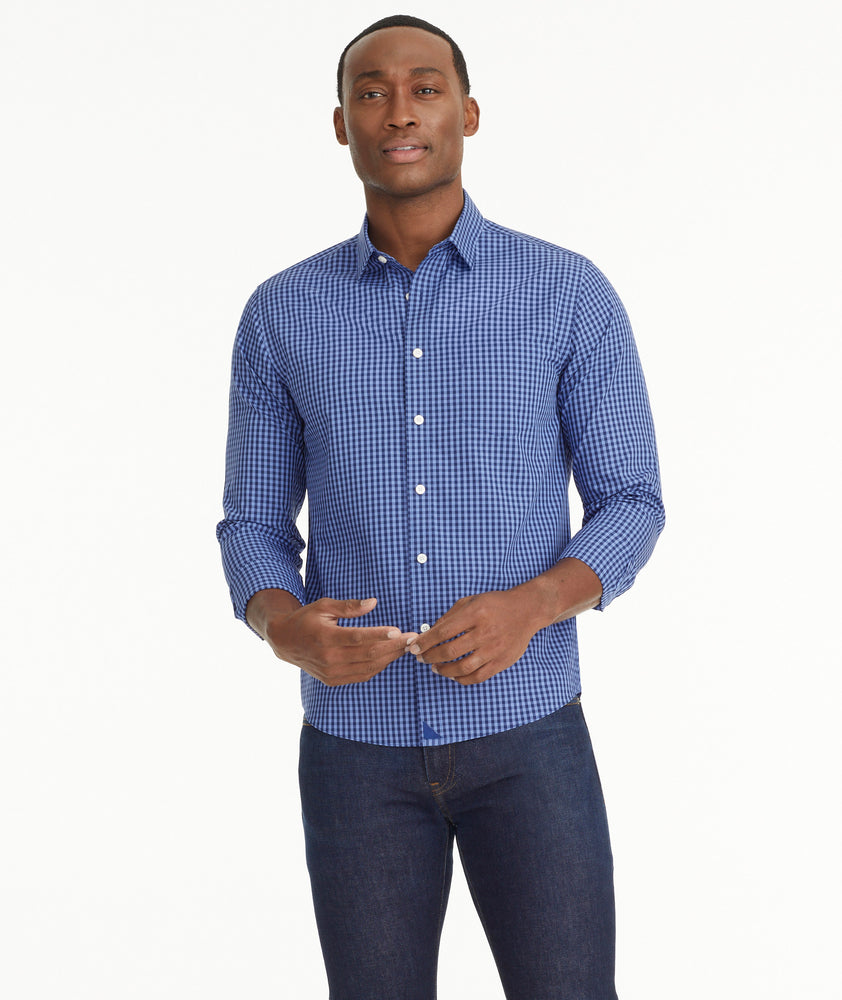 Model is wearing UNTUCKit Wrinkle-Free Alberdi Shirt in Blue & Navy Gingham