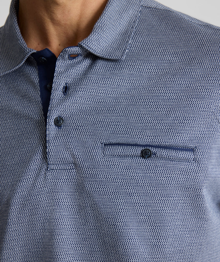 Model is wearing UNTUCKit Textured Cotton Polo in Navy. 