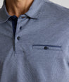 Model is wearing UNTUCKit Textured Cotton Polo in Navy. 
