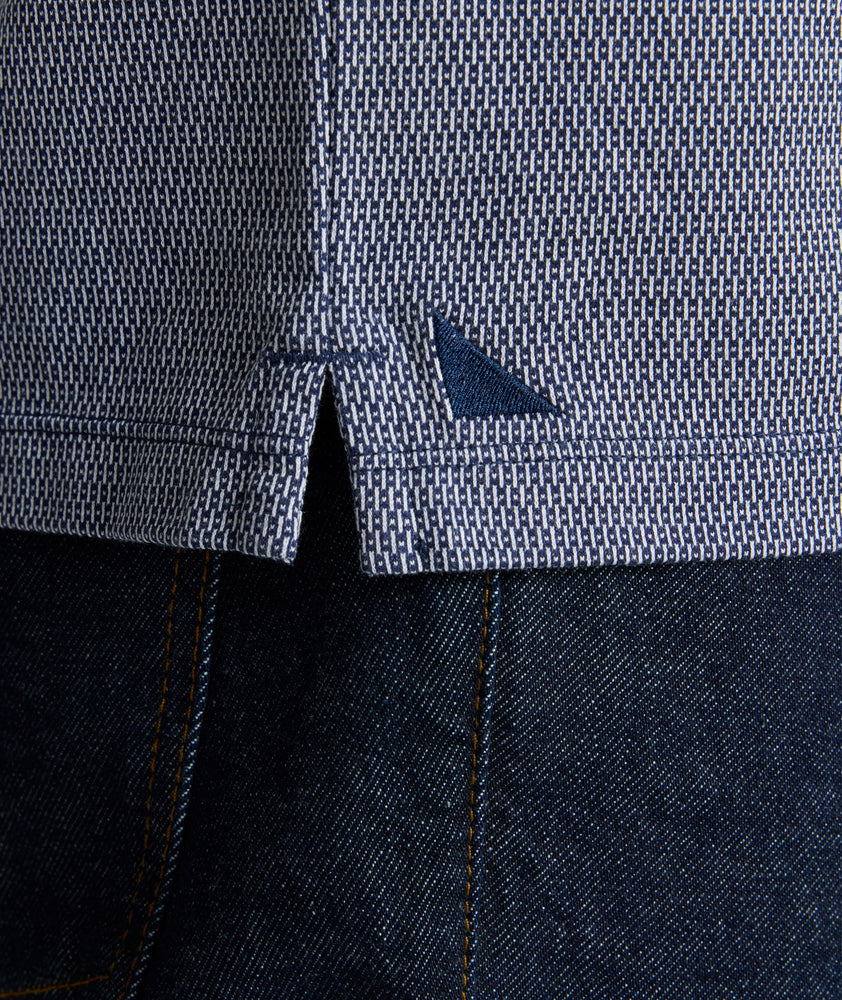Model is wearing UNTUCKit Textured Cotton Polo in Navy. 