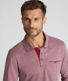 Model is wearing UNTUCKit Textured Cotton Polo in red. 