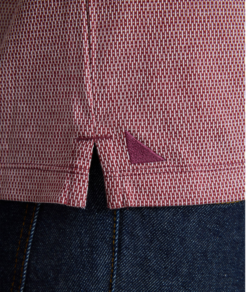 Model is wearing UNTUCKit Textured Cotton Polo in red. 