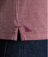 Model is wearing UNTUCKit Textured Cotton Polo in red. 